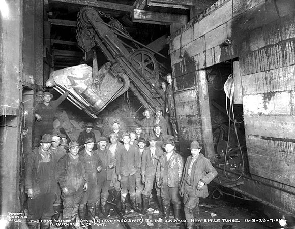 tunnel workers in a black and white photograph
