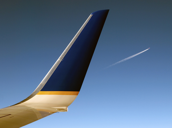 Wingtip and distant airplane