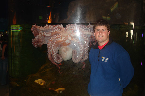 Alex standing in front of octopus tank
