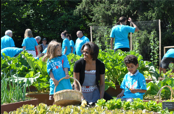 Michelle Obama planting in a garden with children