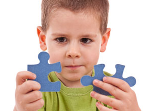 A child playing with a jigsaw puzzle