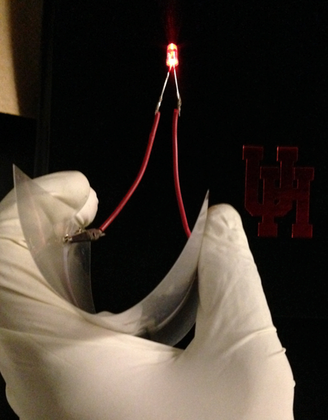 Figure 1. A flexible thin-film battery made with solid polymer electrolyte lighting a red LED (Courtesy of Ardebili's Research Lab at University of Houston)1