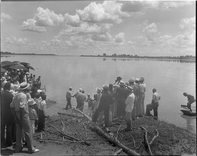 Baptism by immersion in the Mississippi River, May 29, 1938: ankle-deep in water