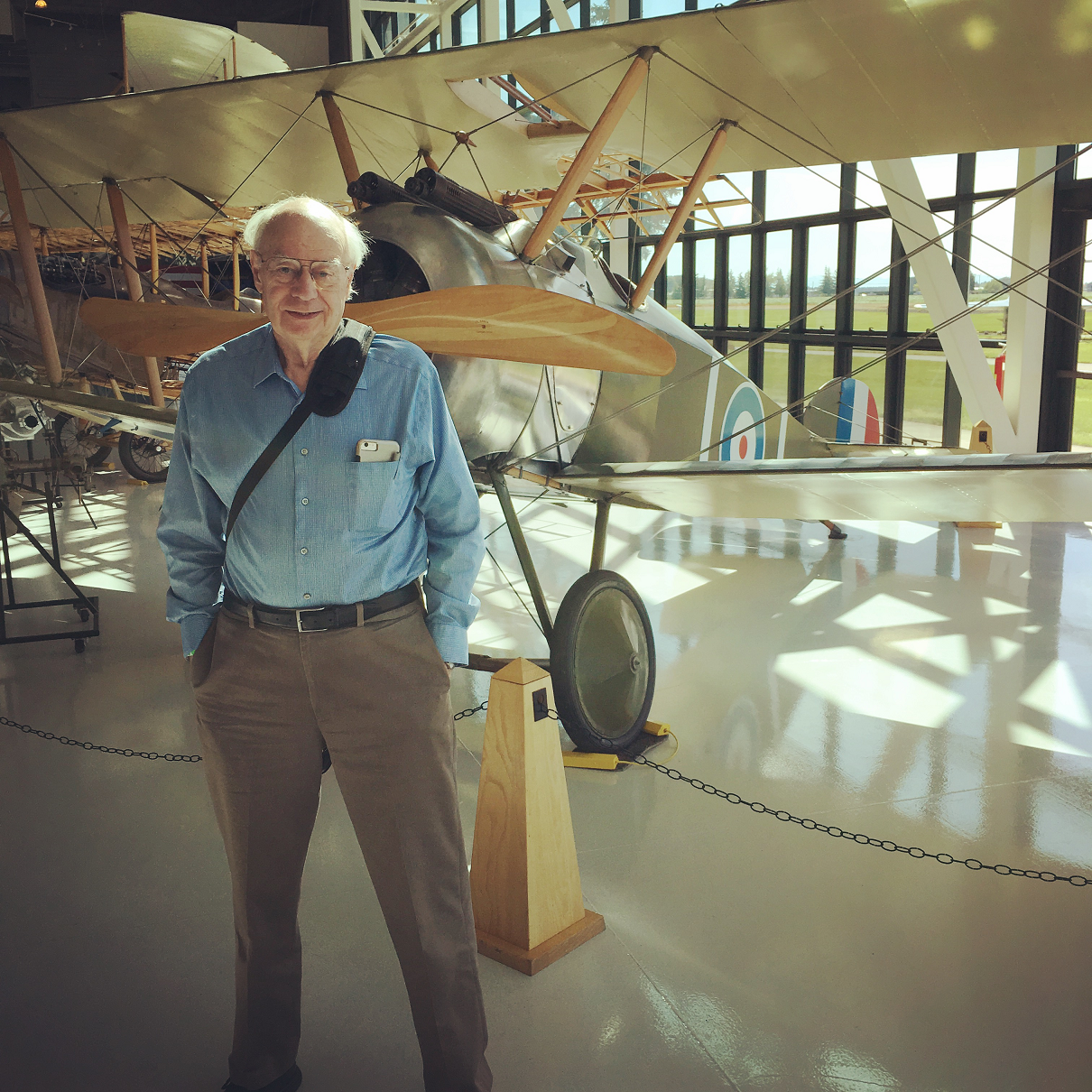 John in front of the type of airplane his father flew