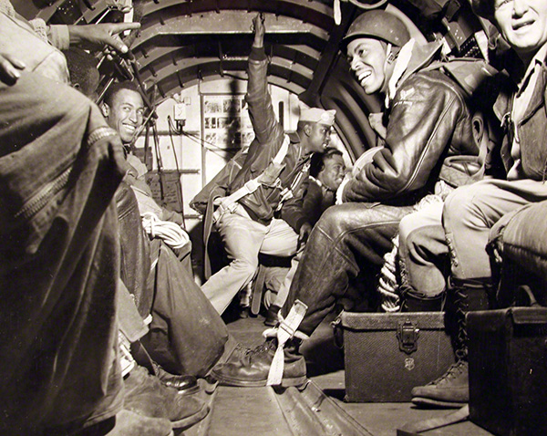 Military officers getting ready to jump out of plane