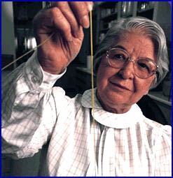 Stephanie Kwolek holding strand of Kevlar