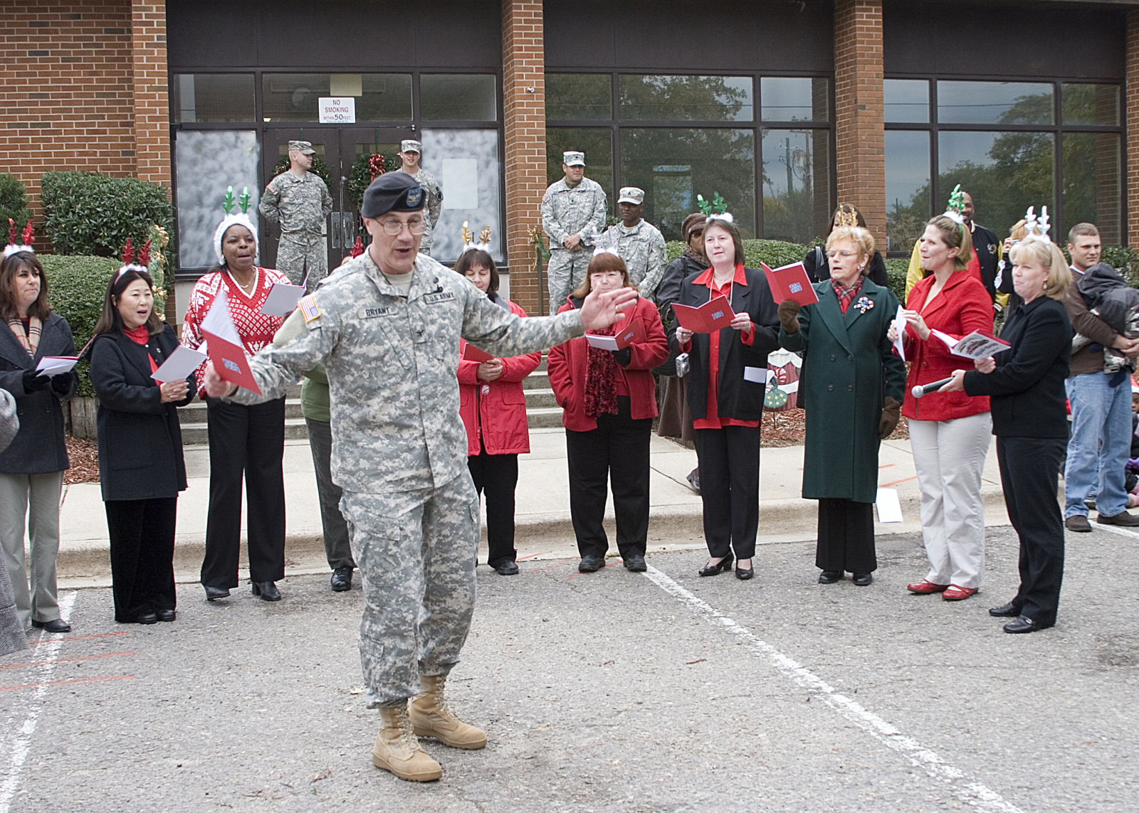 army col leads personnel caroling songs