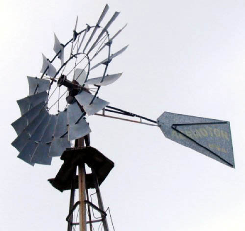 The venerable Aeromotor farm windmill. The tail vane roughly controls its speed.