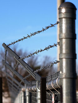 Barbed wire fence topping