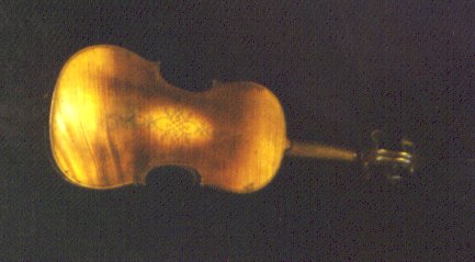 This baroque violin reveals its age in its short neck and in the unusual inlaid pattern on the back