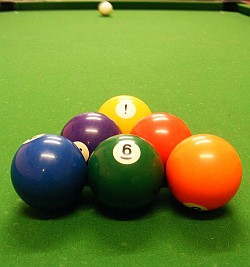 The balls on a billiard table are subject to classical physics, such as the conservation of energy