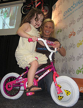 child being assisted on a bike