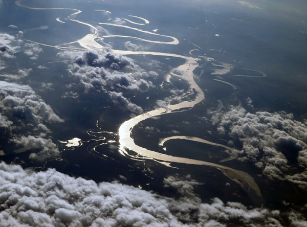 Meandering river under clouds