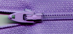 A typical plastic zipper for present-day clothing.