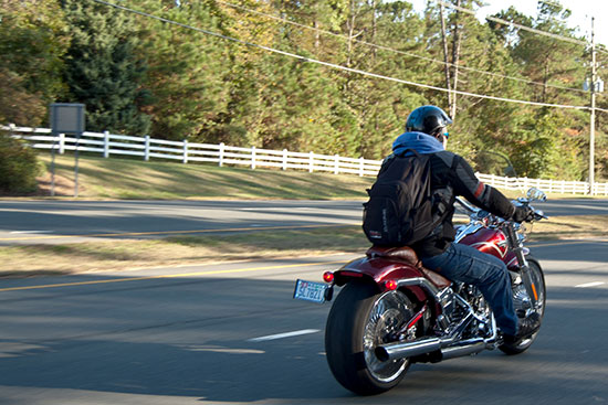 man riding a red motorcycle