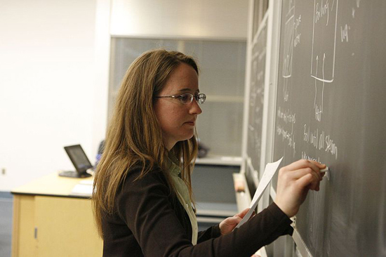 image of teacher writing on the chalkboard
